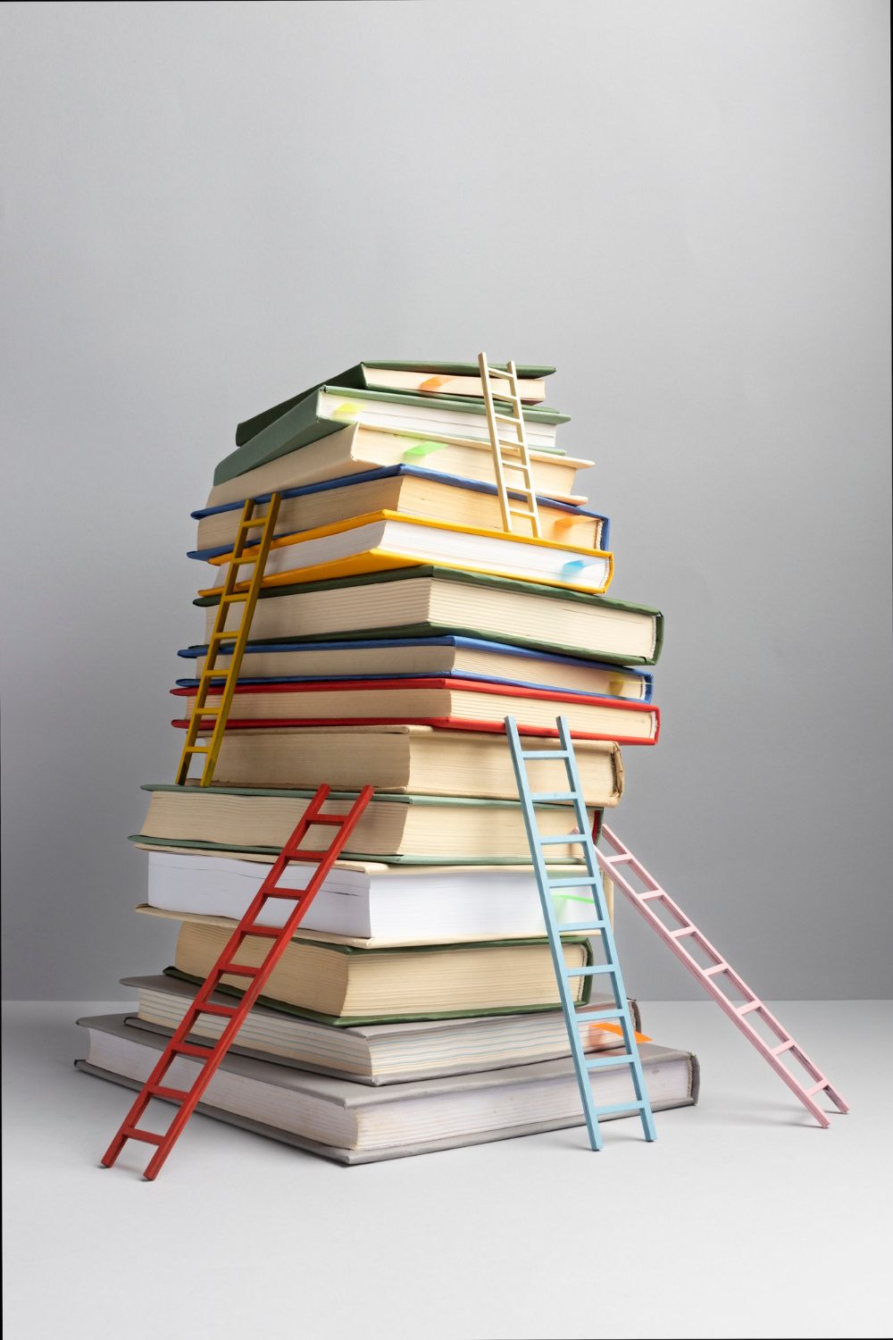 front-view-stacked-books-ladders-with-copy-space-education-day